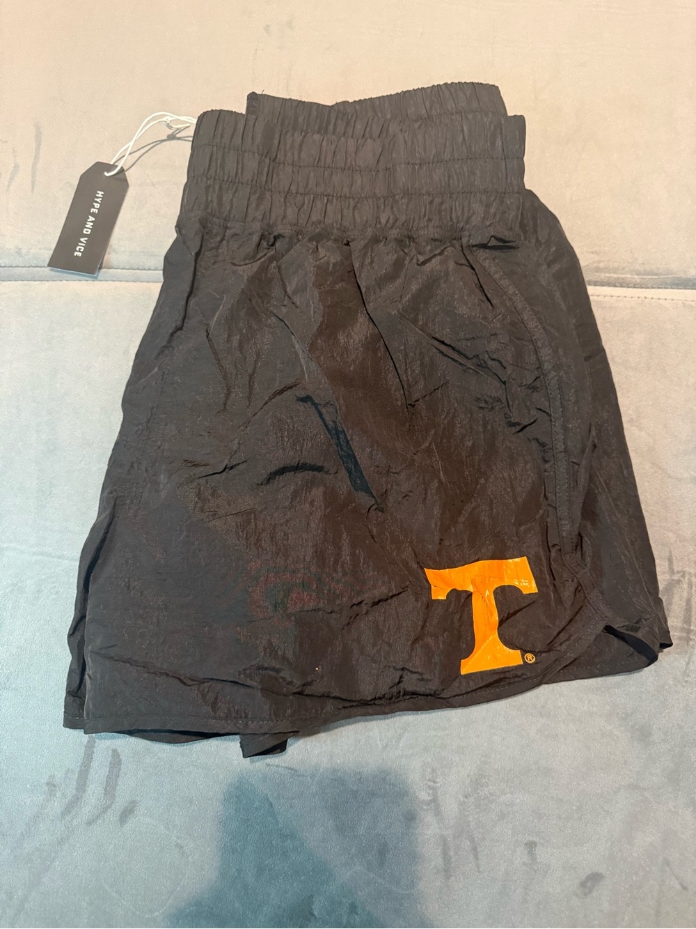 Black Athletic Shorts with Orange 'T' Accent